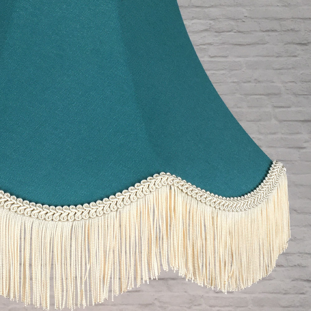 Close-up of teal brushed cotton lampshade fabric with dark cream feather trim