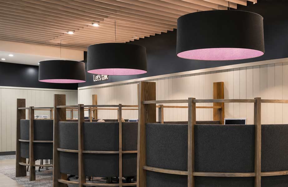 Wholesale Black Drum Pendant Lamp Shades | Imperial Lighting Black drum pendant lamp shades with pink interiors above booth seating in a commercial space.