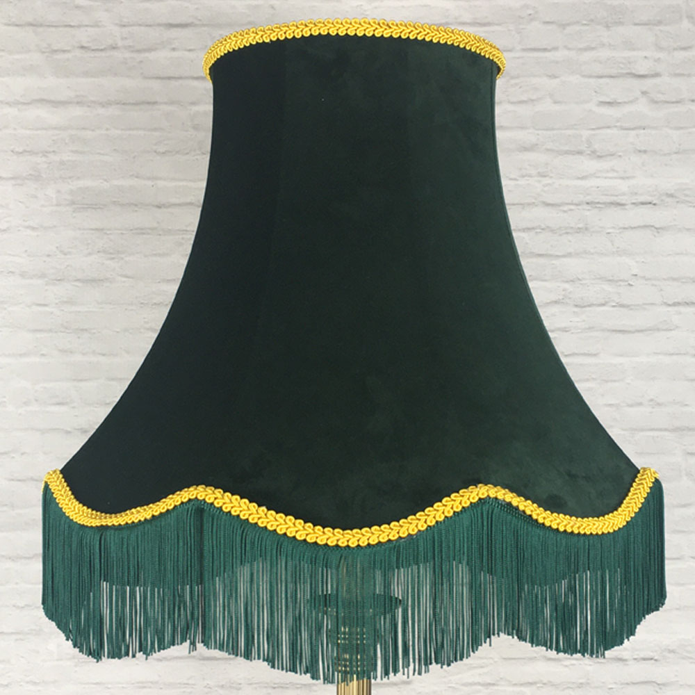 Dark green velvet scalloped bowed empire lampshade with yellow feather trim and green fringe on floor lamp