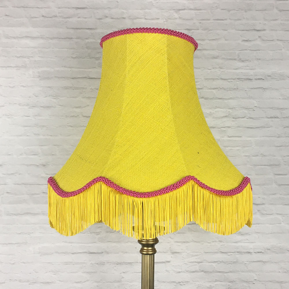 Yellow hessian scalloped bowed empire lampshade with pink trim and yellow fringe on floor lamp