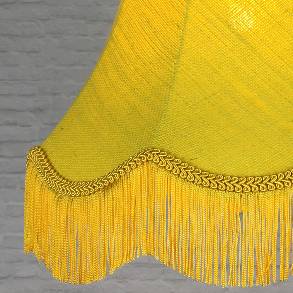 Close-up of yellow hessian lampshade fabric with yellow feather trim