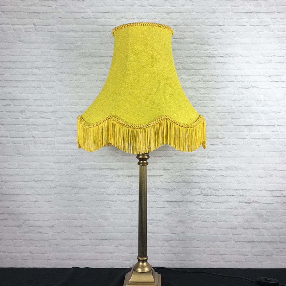 Yellow hessian scalloped bowed empire lampshade on table lamp