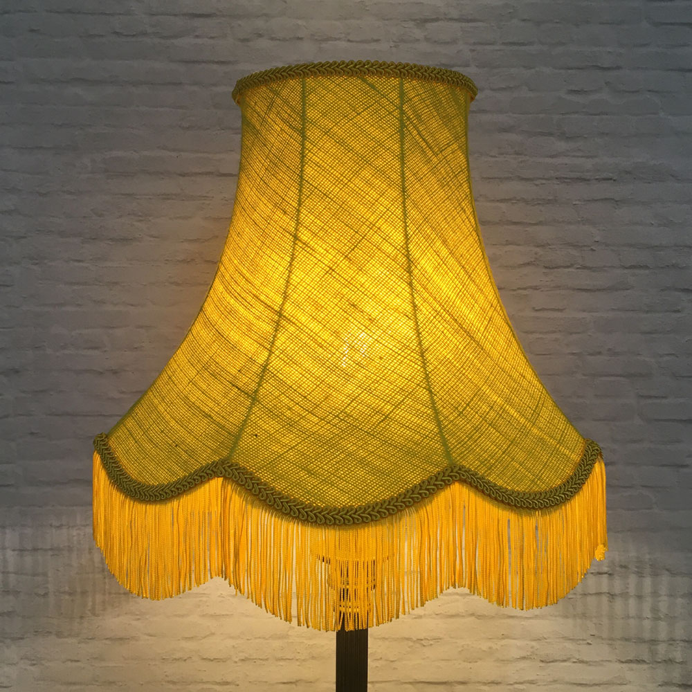 Illuminated yellow hessian scalloped bowed empire lampshade on floor lamp