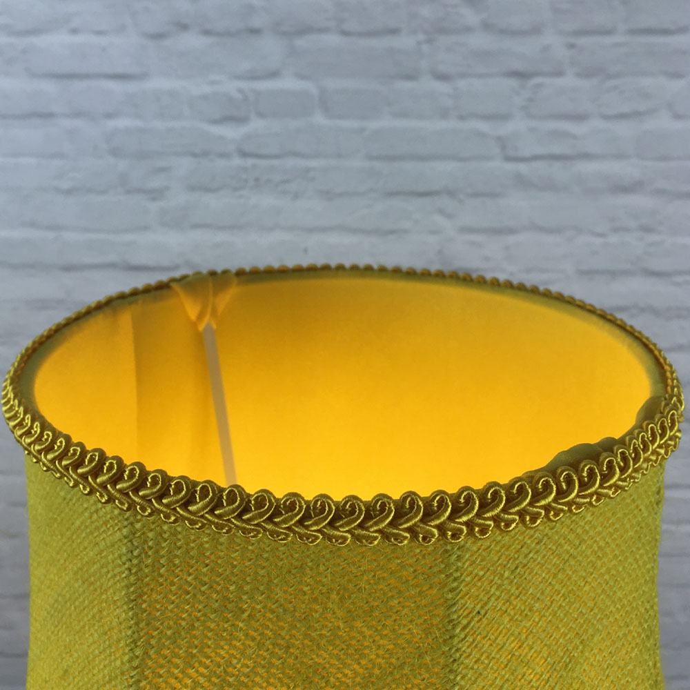 Close-up of yellow feather trim, yellow hessian fabric and inner lining on scalloped bowed empire lampshade